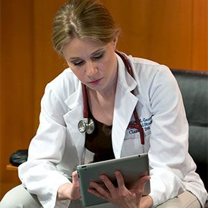 medical student studying material on her tablet