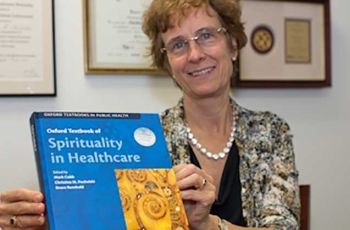 Dr. Puchalski holding Spirituality and Healthcare