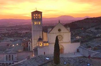 A sunset over a church in Assisi, Italy
